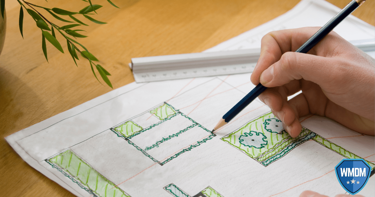 Landscaper drawing a professional landscaping plan.
